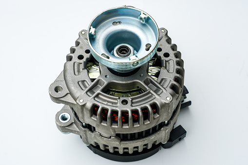 New modern car power generator with clutch pulley shaft on a white background. Vertical view
