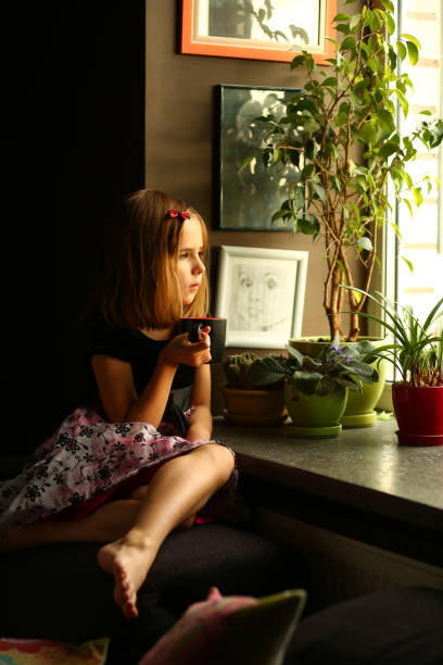 istock Cute thoughtful girl near the window 1443608068