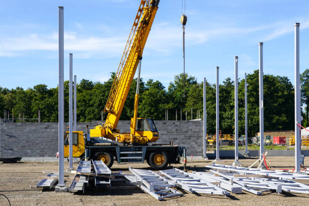 istock Construction site of a new industrial building with vertical steel columns and a telescopic crane 1443608096