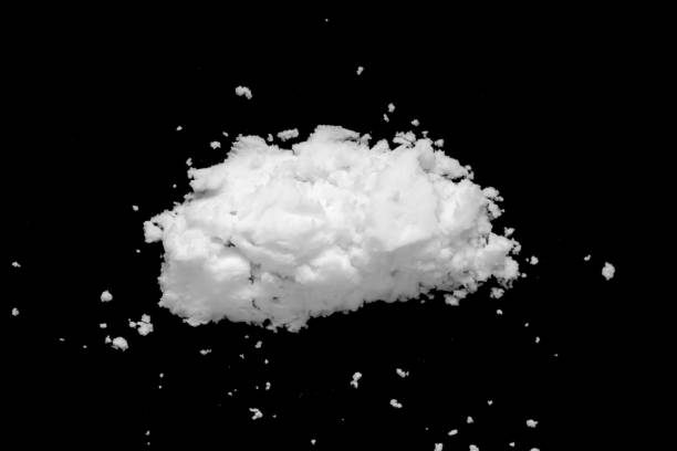 istock White snow isolated on black background close up 1443608814
