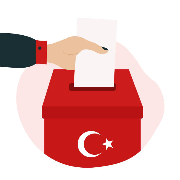 istock Turkey 2023 president elections illustration. Hand puts paper in box with Turkish flag. 1443609078