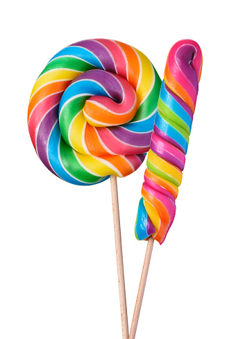 Two colorful lollipop swirl spiral big candies on wooden stick rainbow colored isolated on white background