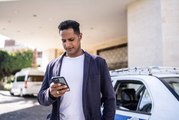 Mid adult man using smartphone outdoors