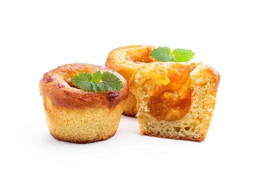 Freshly  baked muffins with apricot jam filling isolated on white