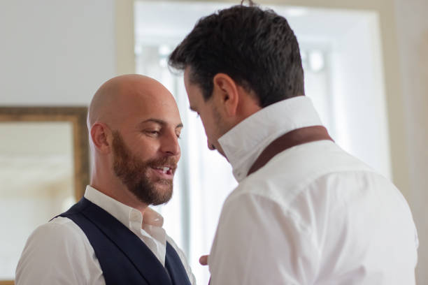 istock Cheerful man tying partners necktie in hotel room 1443614981