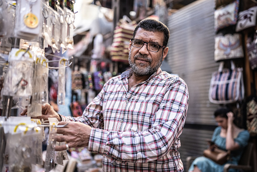 Portrait of a business owner arranging things in his store