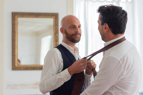 istock Man tying his partners necktie in hotel room 1443615524