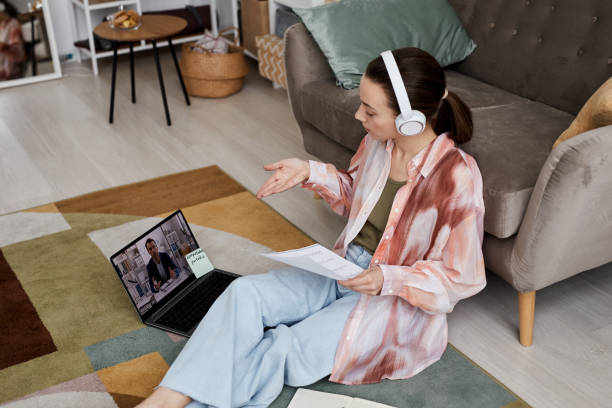 istock Young confident woman in headphones communicating with tutor 1443617845