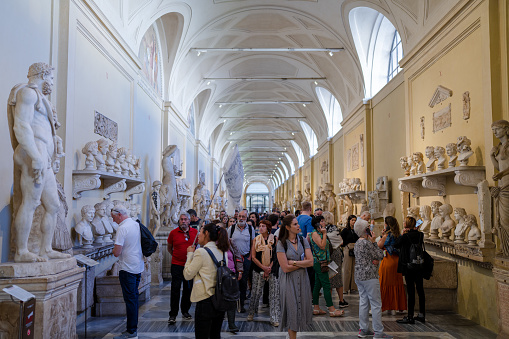 Vatican City - October 3 2022: Tourists Looking at Ancient Sculptures of Romans in the Hallway of the Chiaramonti Museum in Vatican City