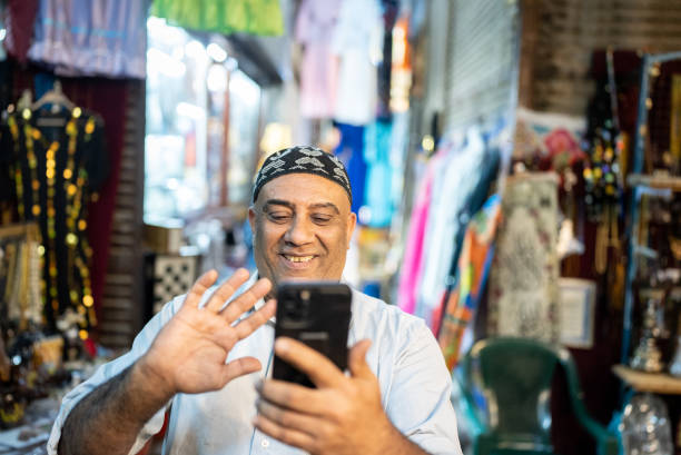 Mature man doing a video call on smartphone outdoors