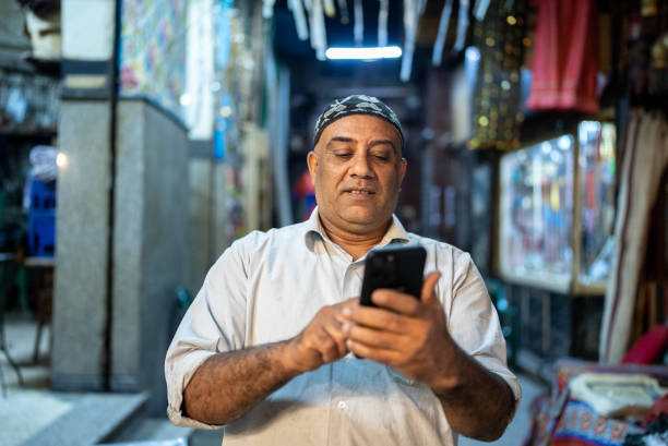 Mature man using smartphone outdoors