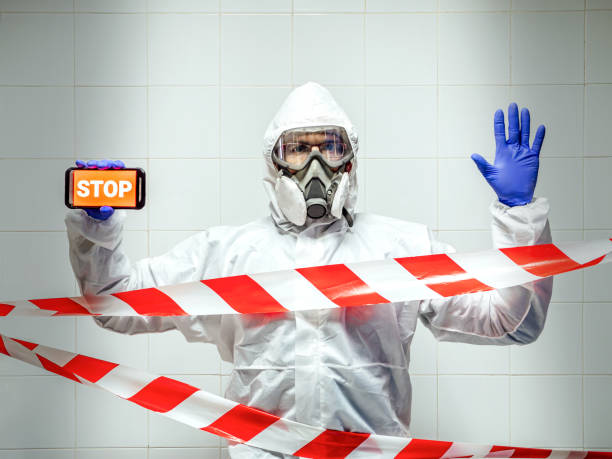 istock Man in chemical protective suit making stop gesture. 1443619142