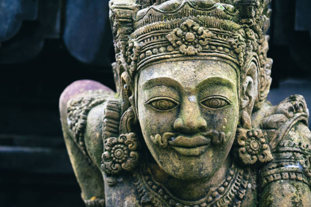 Traditional sculpture made of stone seen in the jungle of the Bali island, Indonesia.