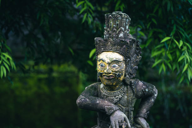 Traditional demon sculpture made of stone in the jungle of the Bali island, Indonesia.