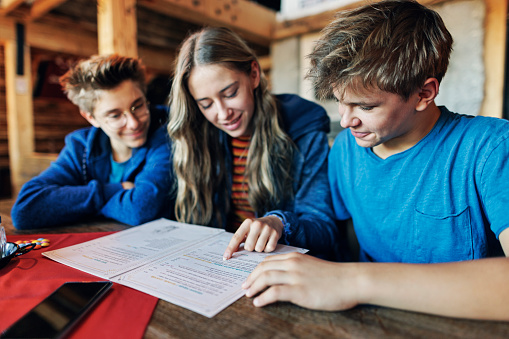 Teenage kids in restaurant, reading menu and choosing their lunch.
Canon R5