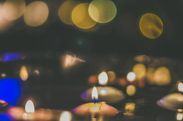 istock symbolic christmas tradition with candles floating on water, 1443623041