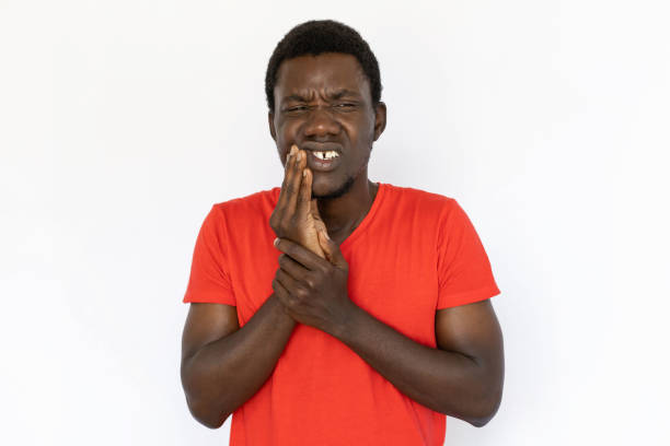Portrait of frustrated African American man with toothache stock photo