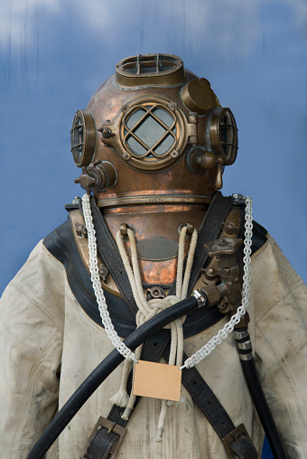 A Diving Suit With A Round Copper Helmet.
