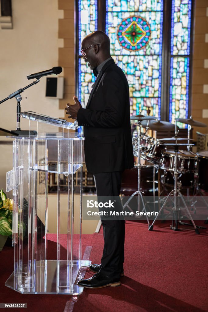 Black Congregation attend Black Baptist Church service Group of African Americans attending church and listening to a pastor speak. Christianity Stock Photo