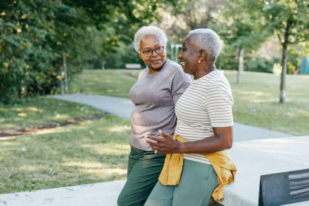 istock Two seniors friends chatting  in the park 1443625766