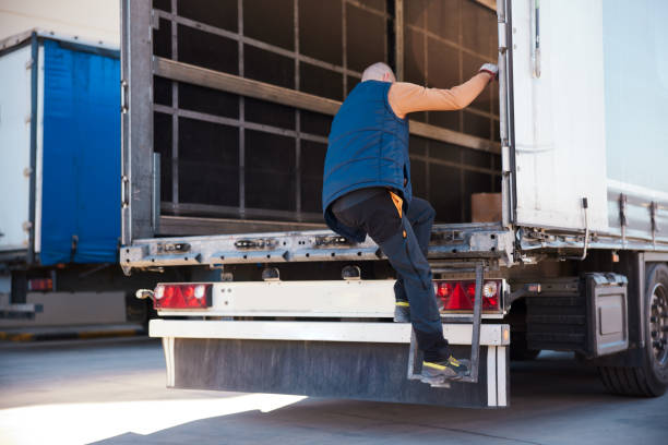 istock Truck driver climbing into the vehicle trailer 1443626910
