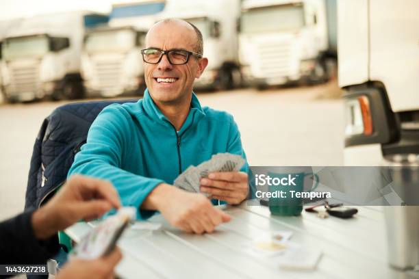 Game Of Cards For These Truck Drivers At A Truck Stop Stock Photo - Download Image Now