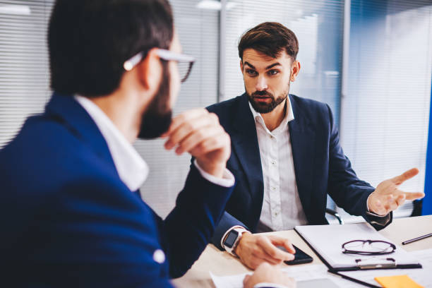 istock Confident male executive managers 30s discussing business strategy during working process at table desktop, Caucasian investors in formal wear have collaborative brainstorming in office interior 1443627252