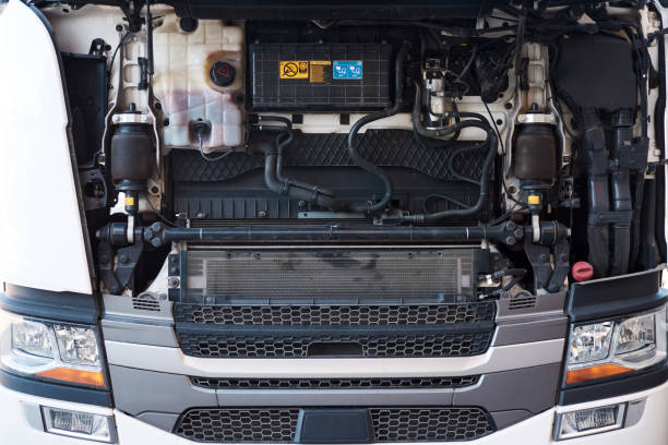 Front panel lifted to access semi-truck tractor front engine. Close-up