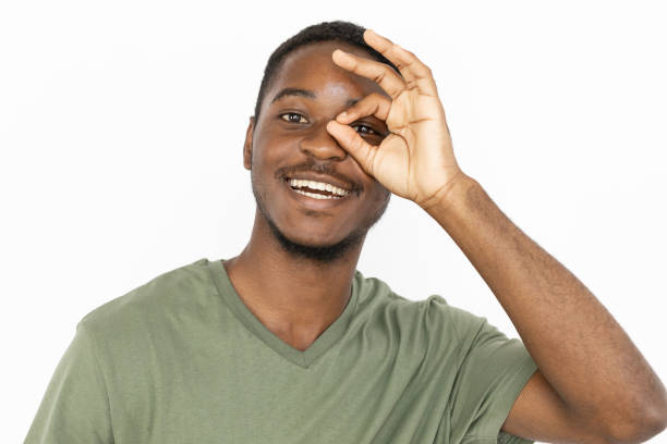 istock Joyful young man showing OK gesture over eye 1443627570