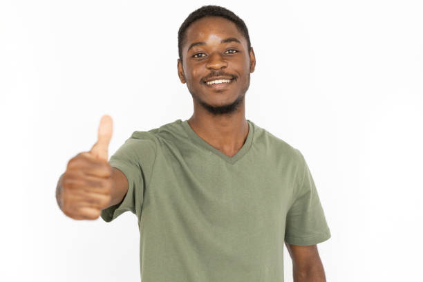 istock Cheerful young man showing thumb up 1443627595