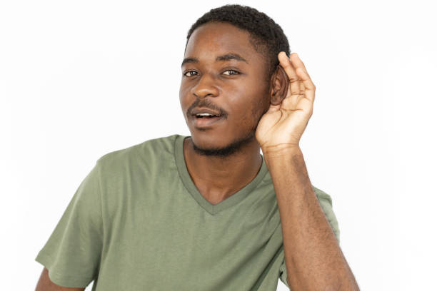 istock Listening young man with hand over ear 1443627601