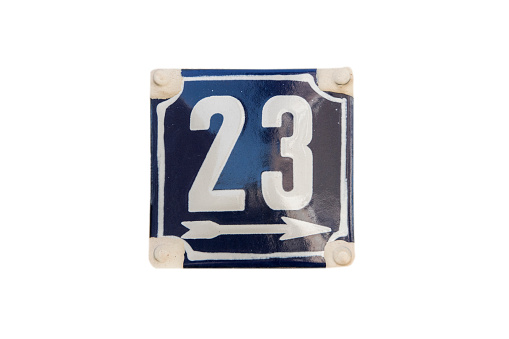 Weathered grunge square metal enameled plate of number of street address with number 23 isolated on white background