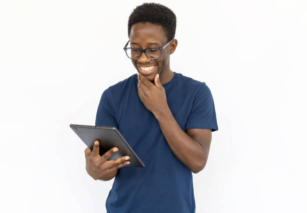 Pleased man checking tablet stock photo