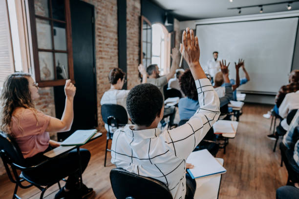 istock Female student raising her hand in the classroom 1443628163