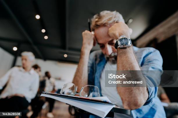 Senior Student Struggling To Study Stock Photo - Download Image Now - Worried, Intelligence, Males