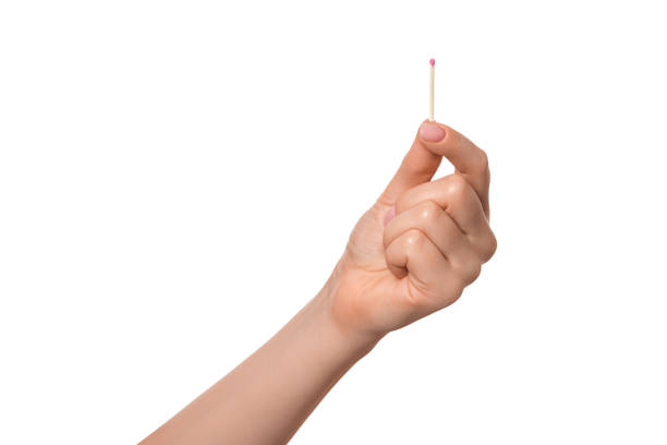 Match in a female hand, isolate. stock photo