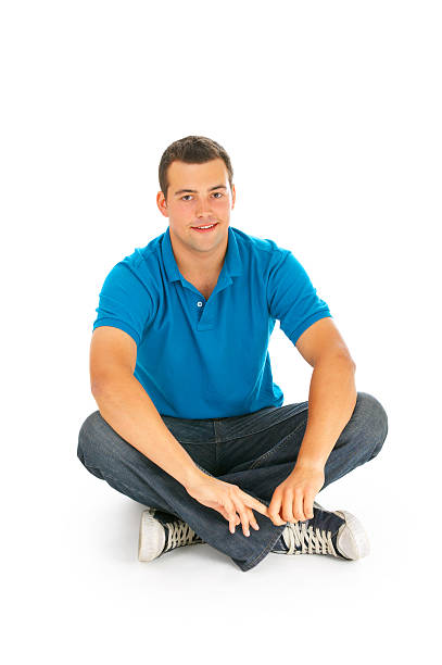 istock Handsom young man sitting on the floor 144363187