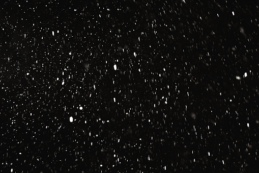 Falling snow on black background. Snowflake. Winter weather. Climate. Storm