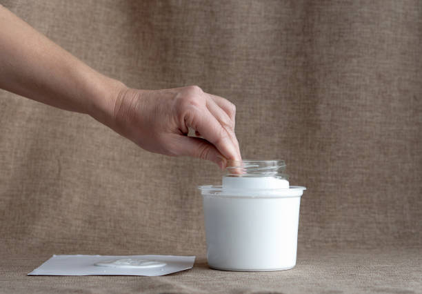 istock Advent Calendar for Christmas. Bank lowered into a container with white paint. 1443633850