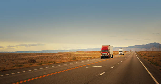 istock Two semi-trucks driving in Utah, USA 1443635084
