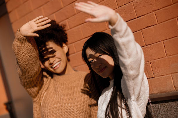 istock Smiling girls standing at the wall 1443635390