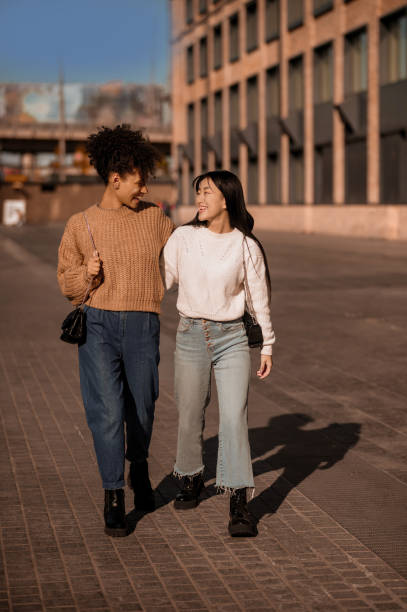 istock Two pretty girls walking and talking, feeling joyful 1443635395