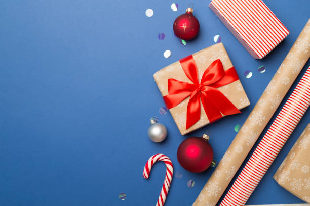 istock Gift boxes, paper's rools and decorations on color background, top view 1443635582