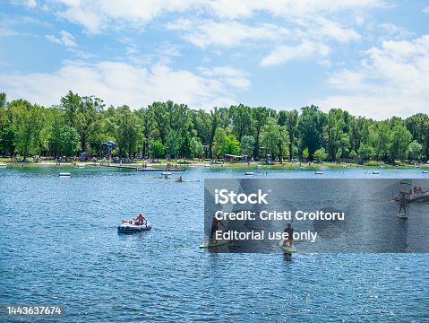 Summer landscape at the beach with people paddling in kayaks and stand up boards in Kaiserwasser Alte Donau park ( Strandbad Gansehaufel)
