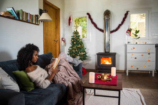 istock Woman reading book in cozy room 1443640348