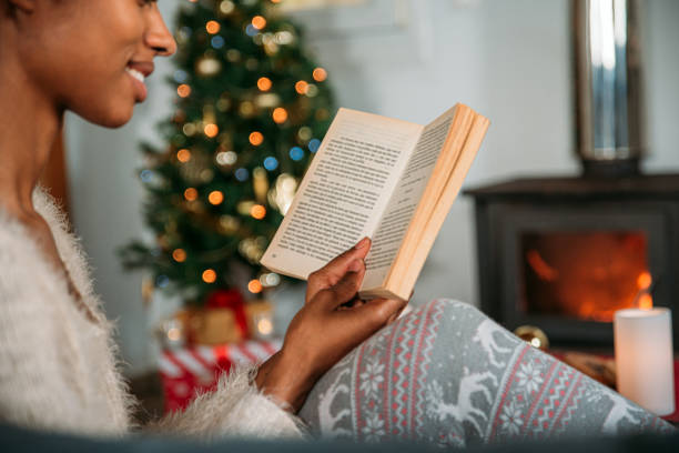 istock Woman reading book in cozy room 1443640663