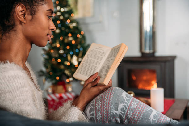 istock Woman reading book in cozy room 1443640669