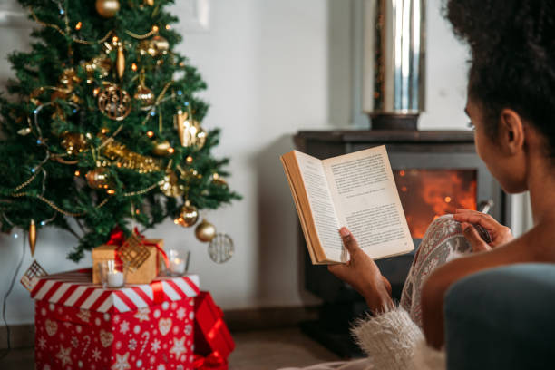 istock Woman reading book in cozy room 1443640690