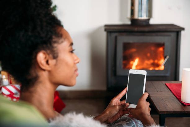 istock woman using smartphone on Christmas 1443640720