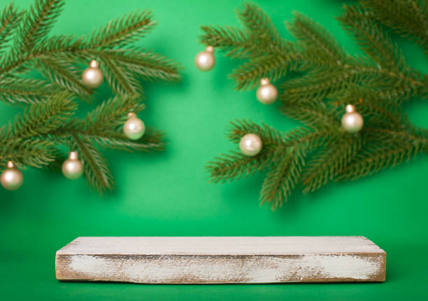istock White wooden plank as platform or podium with copy-space for product presentation over green Christmas background. 1443642678